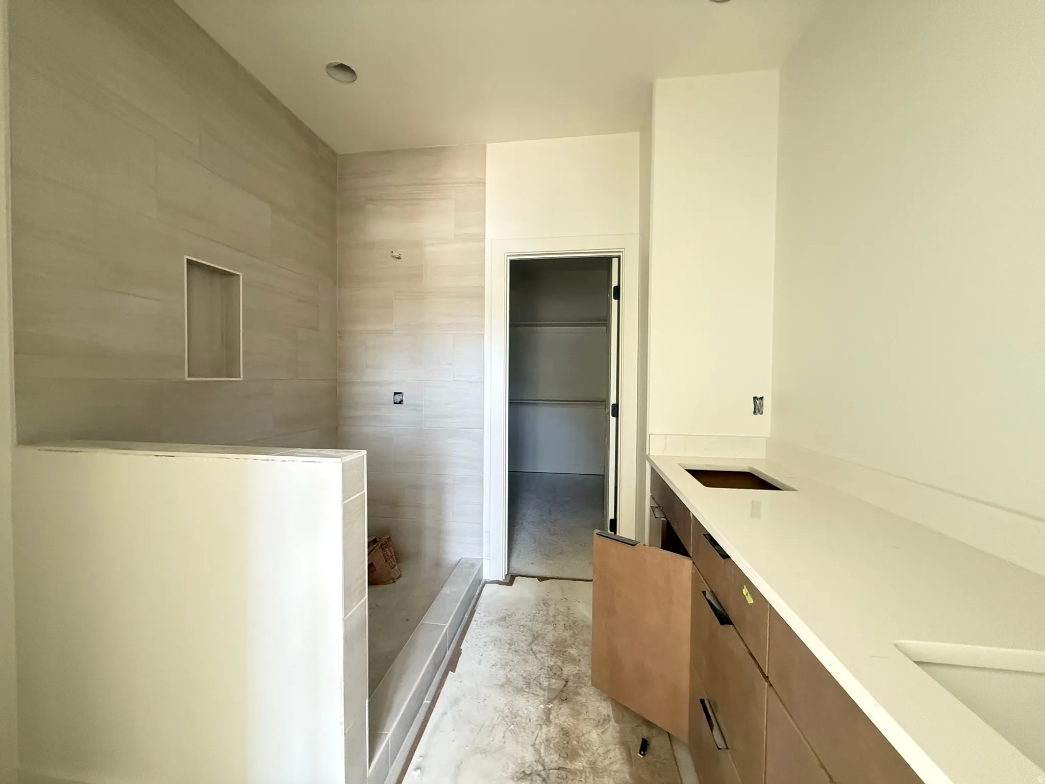Primary bath featuring a double vanity sink, spacious walkin closet, tiled shower to the ceiling with a Full Euro glass.