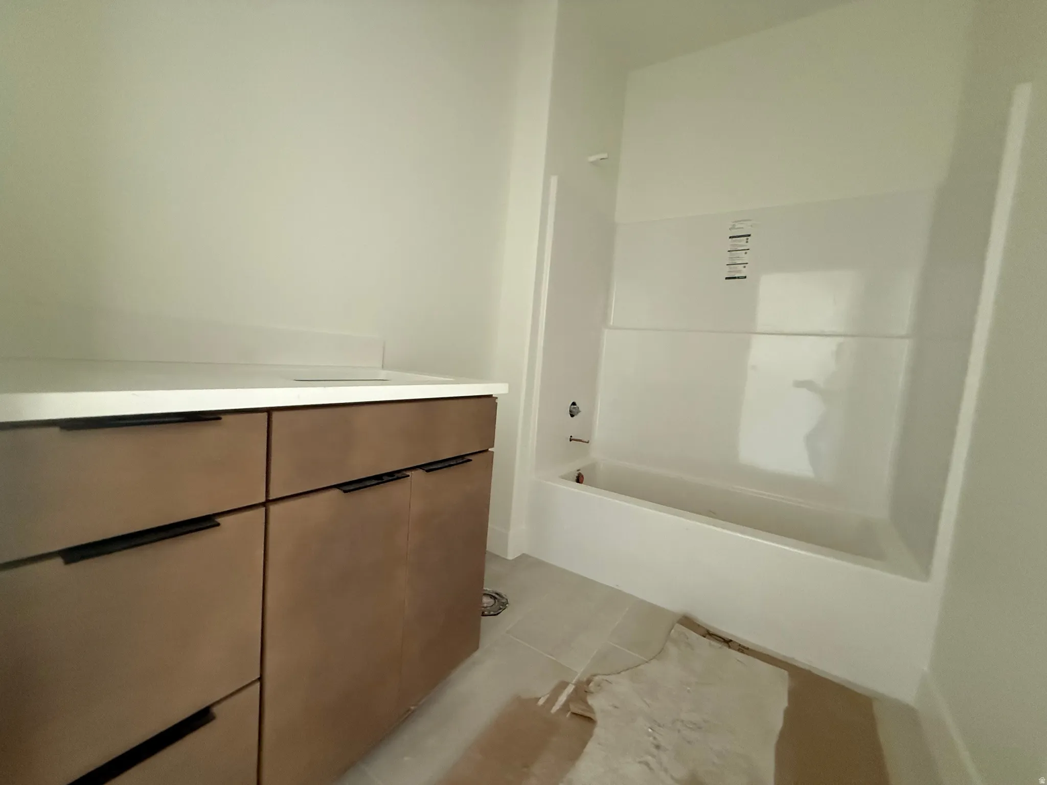 Bathroom with a modern vanity featuring flat-panel cabinetry and matte black hardware