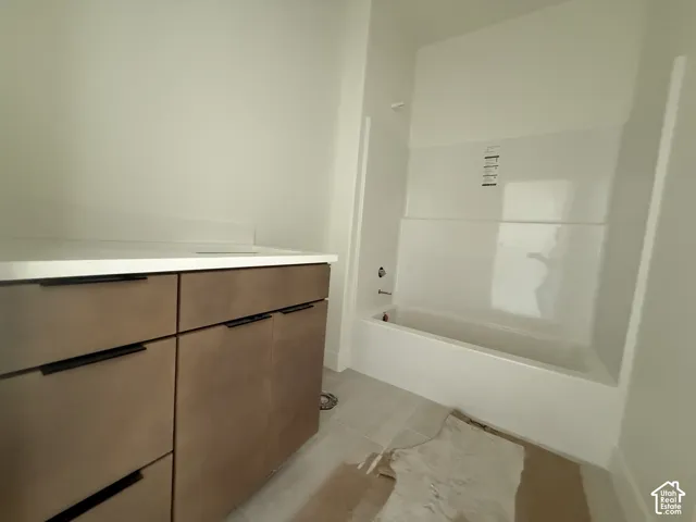 Bathroom with a modern vanity featuring flat-panel cabinetry and matte black hardware
