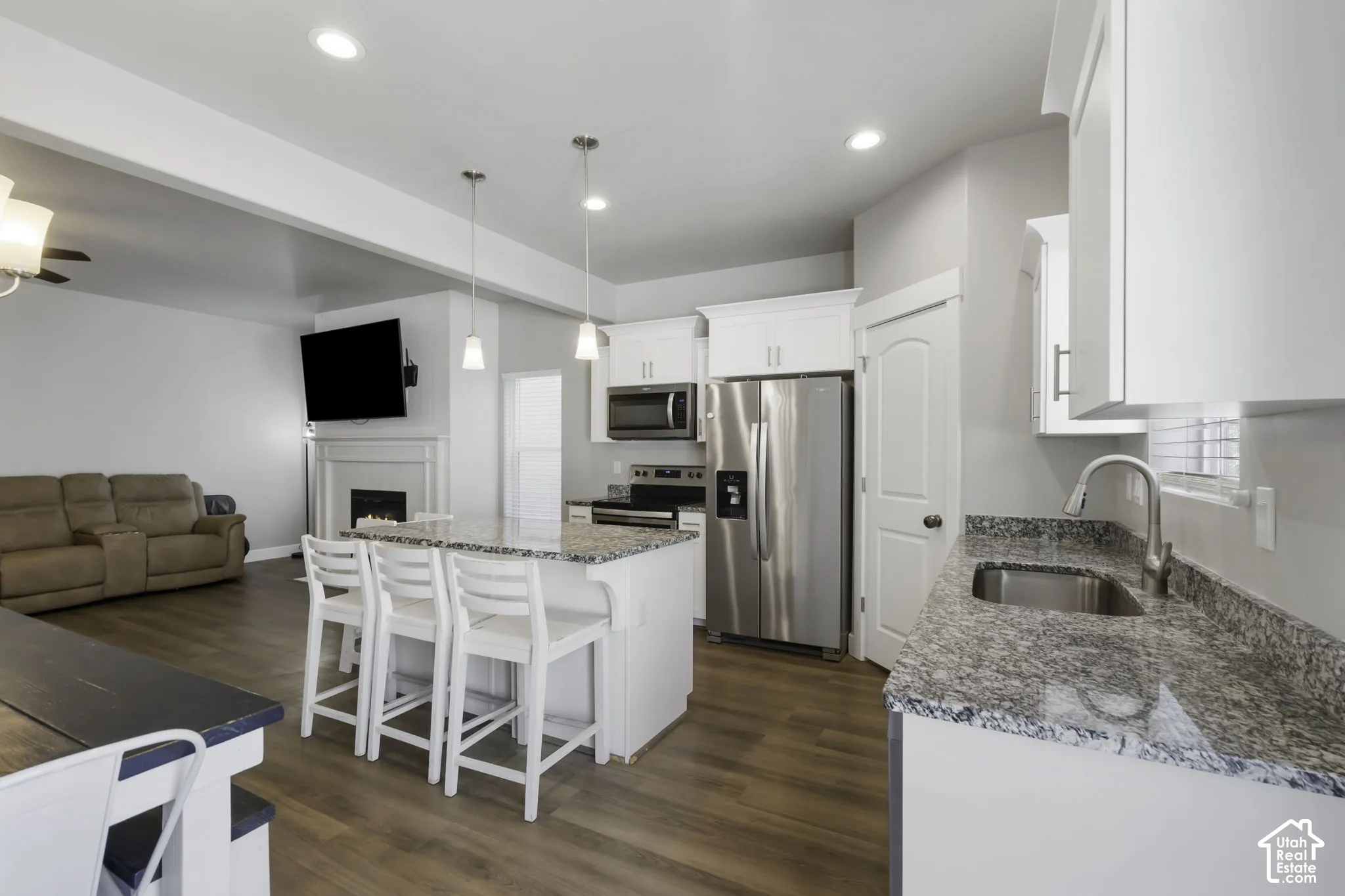 Open-concept kitchen and living area featuring wood-finish flooring