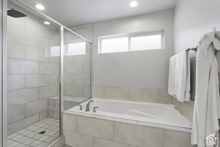 Bathroom featuring a walk-in shower with glass enclosure, rain shower head, and built-in bench