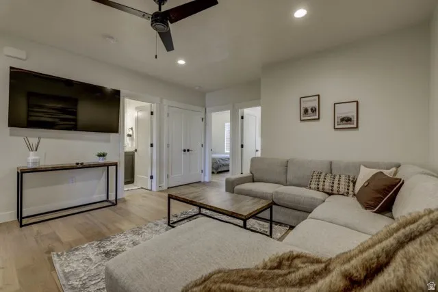 Open concept living area featuring light wood-finish flooring, recessed lighting, a ceiling fan, and white trim