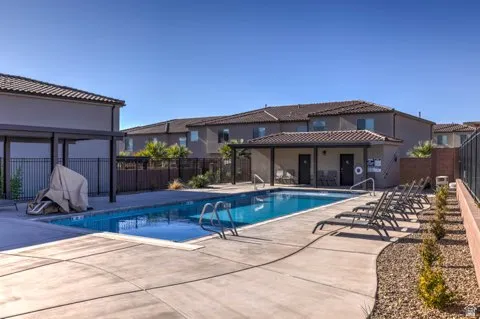 Rectangular swimming pool with integrated steps, surrounded by a concrete deck