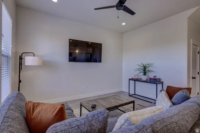 Living area featuring wood-finish flooring, recessed lighting, and a ceiling fan