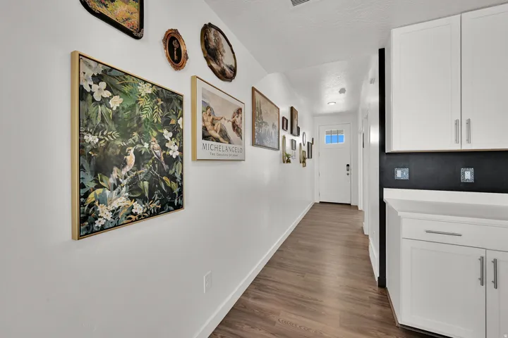 Entryway featuring LVP flooring, white walls, and a white paneled door with glass inserts