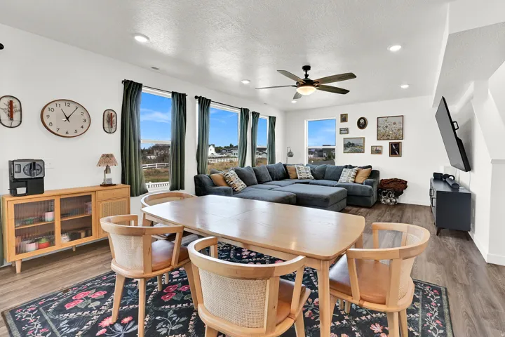 Open-concept living area featuring wood-finish flooring, recessed lighting, and a ceiling fan