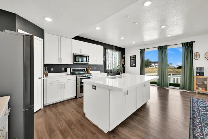 Modern kitchen with LVP flooring and recessed lighting