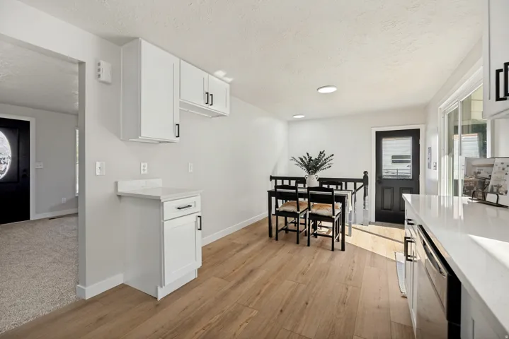 Light wood-finish flooring throughout the dining area and kitchen