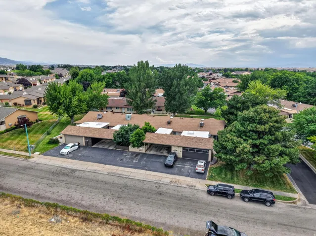 Townhome-style residences featuring attached garages and individual paved parking areas