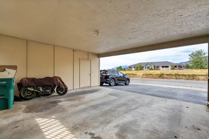 Carport with a concrete pad and direct outdoor access