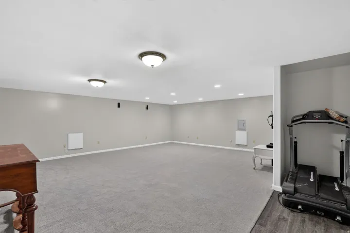 Expansive carpeted room featuring recessed lighting and flush-mount fixtures