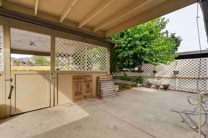 Concrete patio with an overhead cover and an attached lattice privacy screen