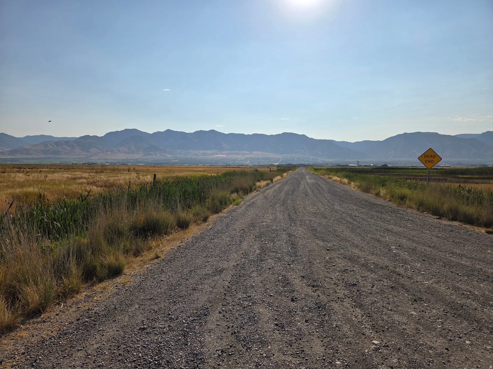 Gravel road extending from paved road