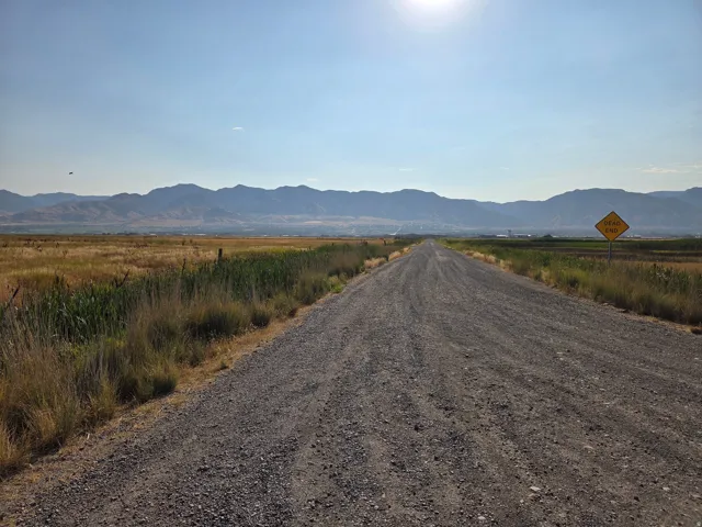 Gravel road extending from paved road