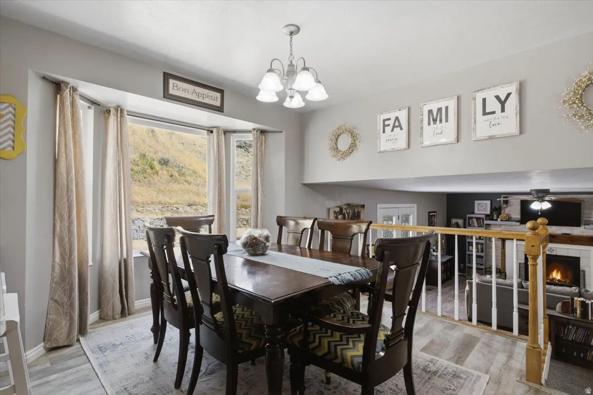 Dining area with a bay window overlooking a natural landscape of mountain views.