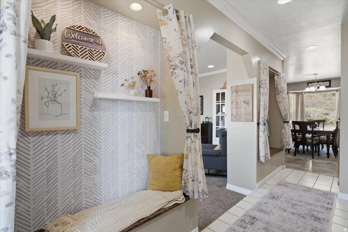 Entryway featuring accent walls with built-in bench seating with storage