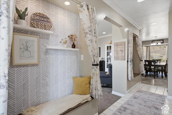 Entryway featuring accent walls with built-in bench seating with storage