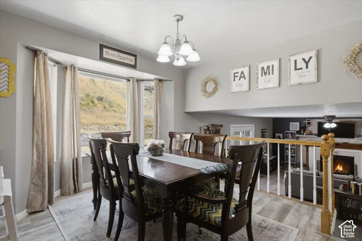 Dining area with a bay window overlooking a natural landscape of mountain views.