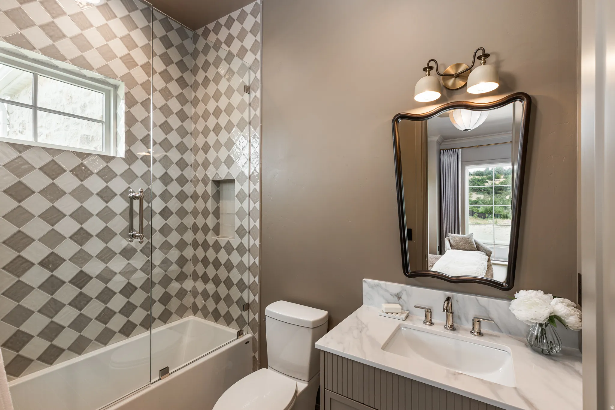 Bathroom featuring a white vanity with fluted cabinet fronts, a white countertop, and an undermount sink with a brushed nickel faucet