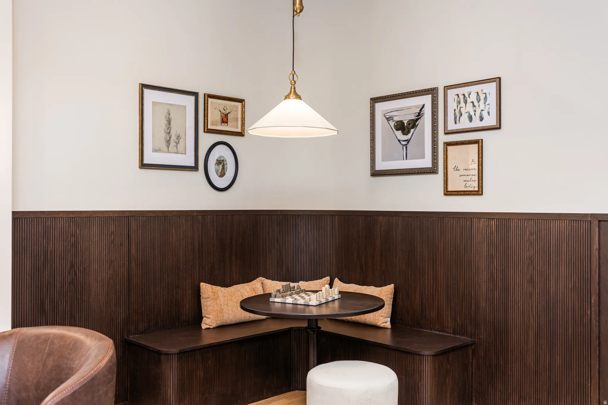 Built-in dark wood banquette seating with fluted paneling