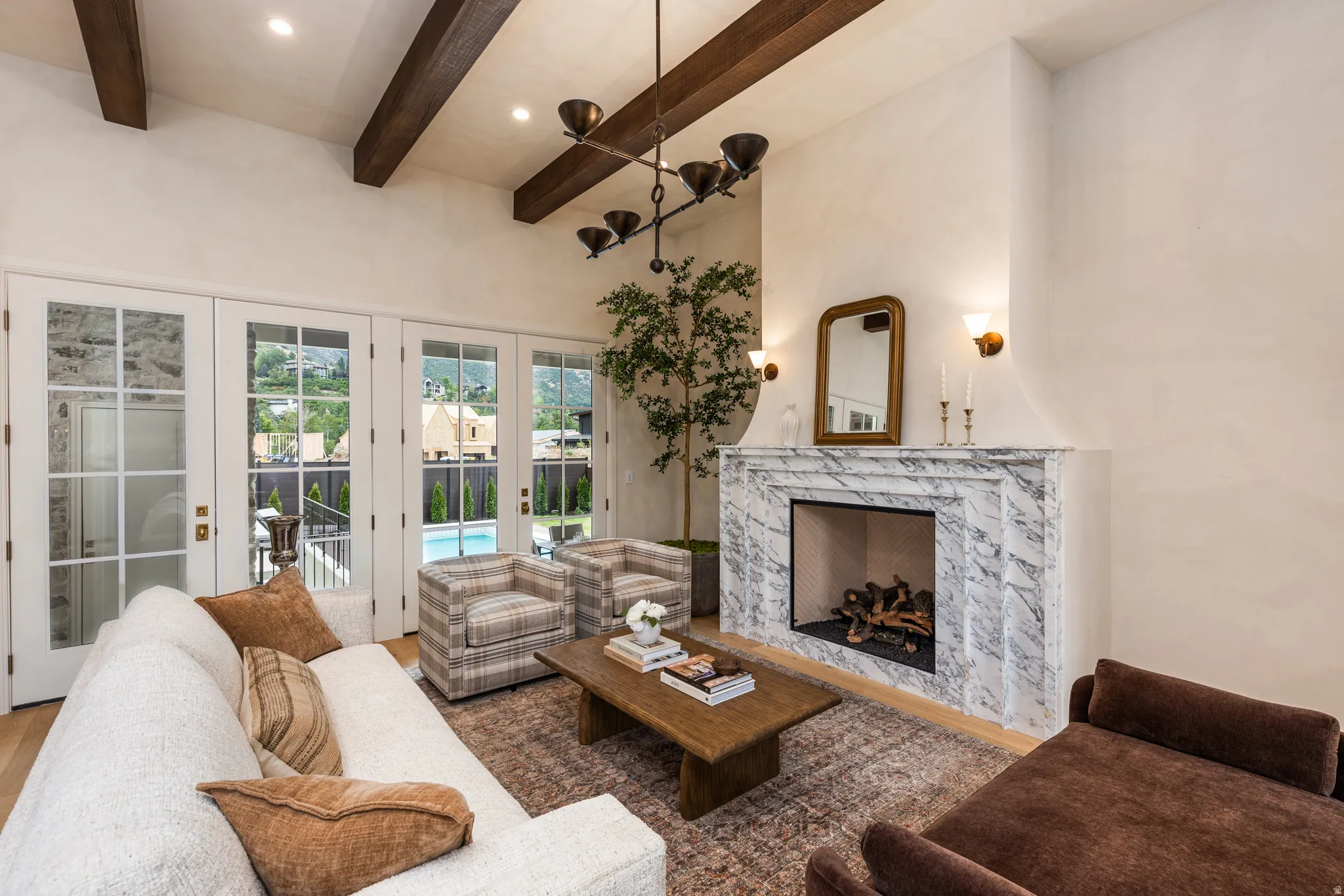Living area featuring a high vaulted ceiling with exposed wood beams
