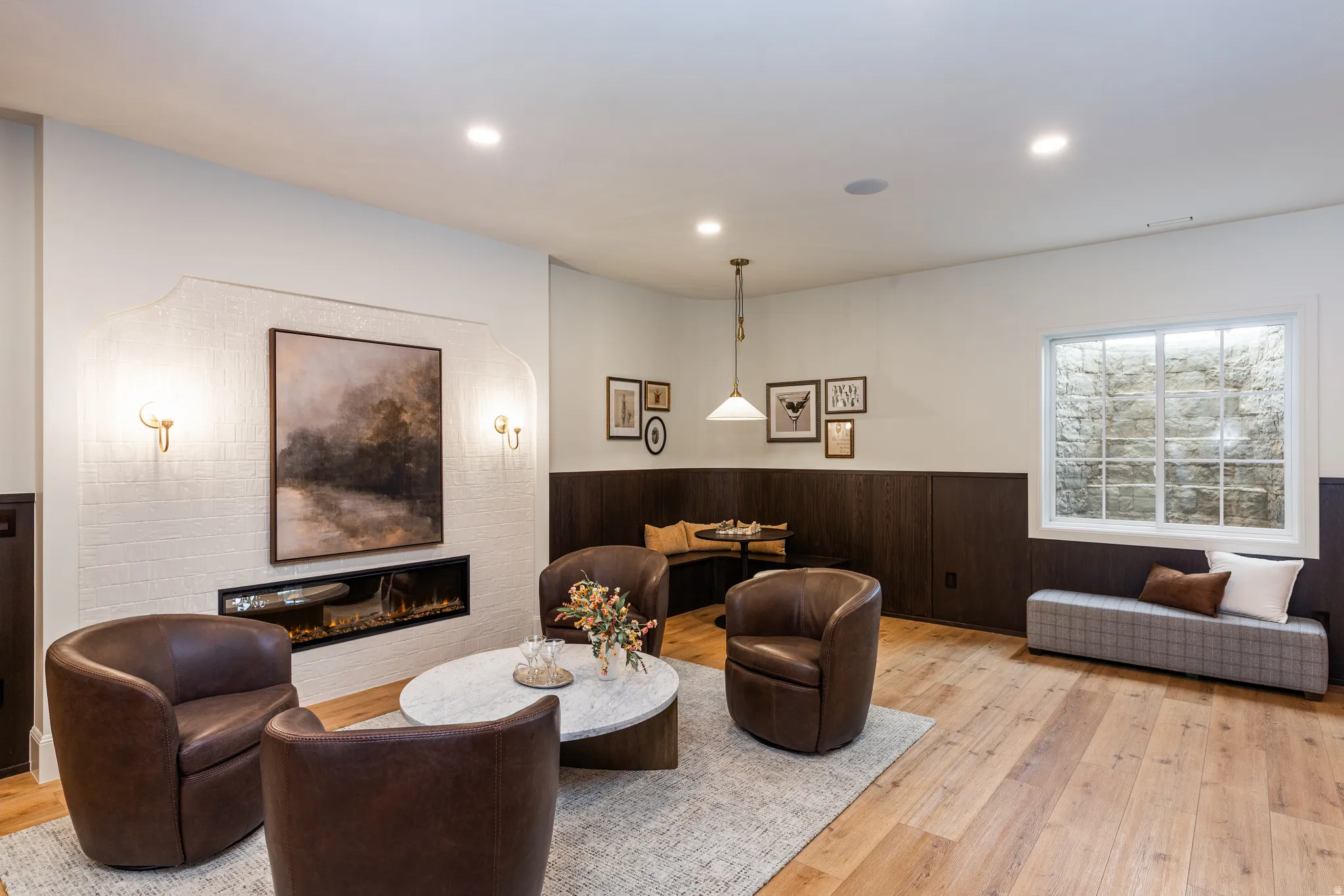 Living area featuring a linear fireplace with white tile surround, recessed lighting, and wood-finish flooring
