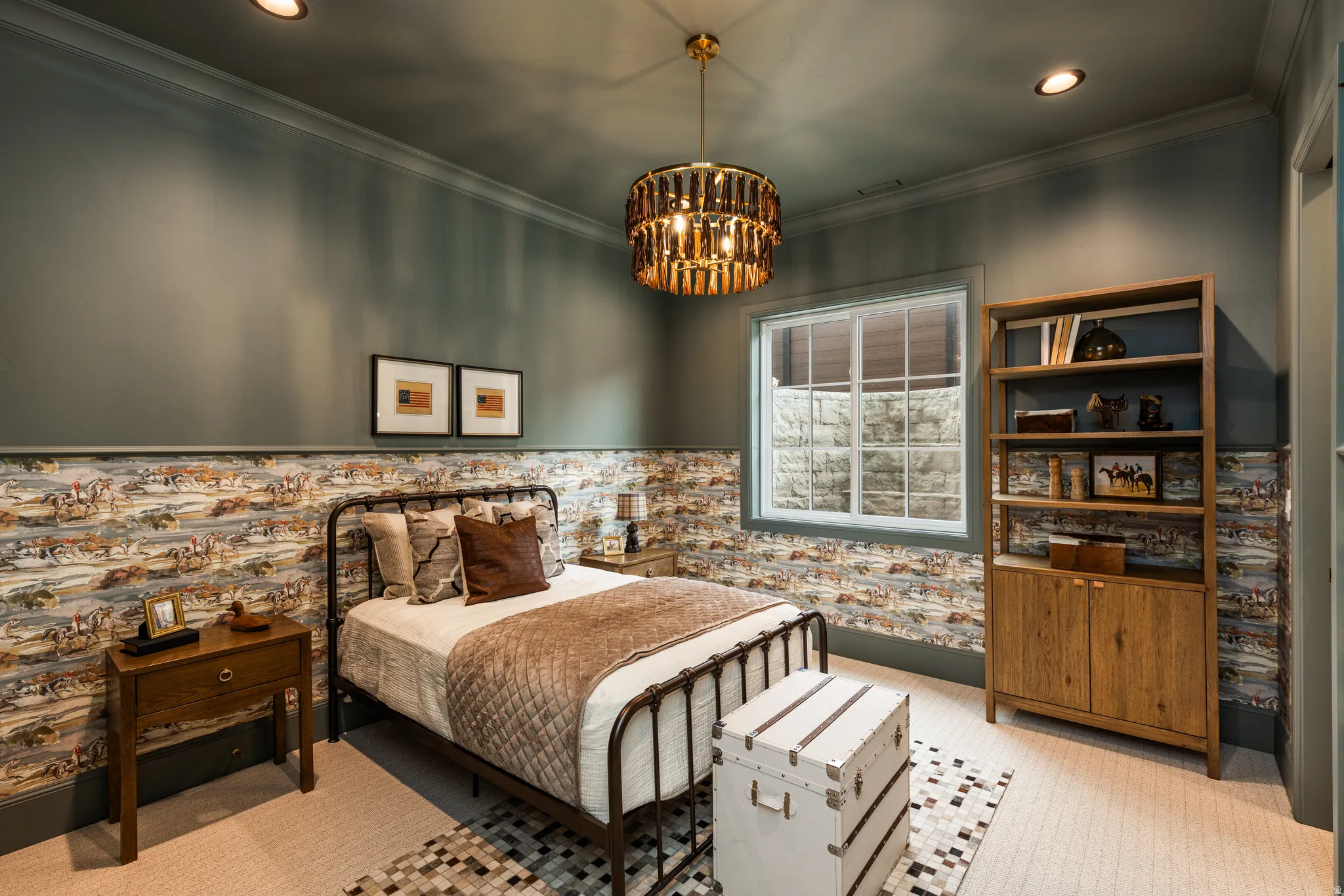 Recessed lighting and a distinctive brass chandelier illuminate this room featuring a window with a stone-textured exterior view