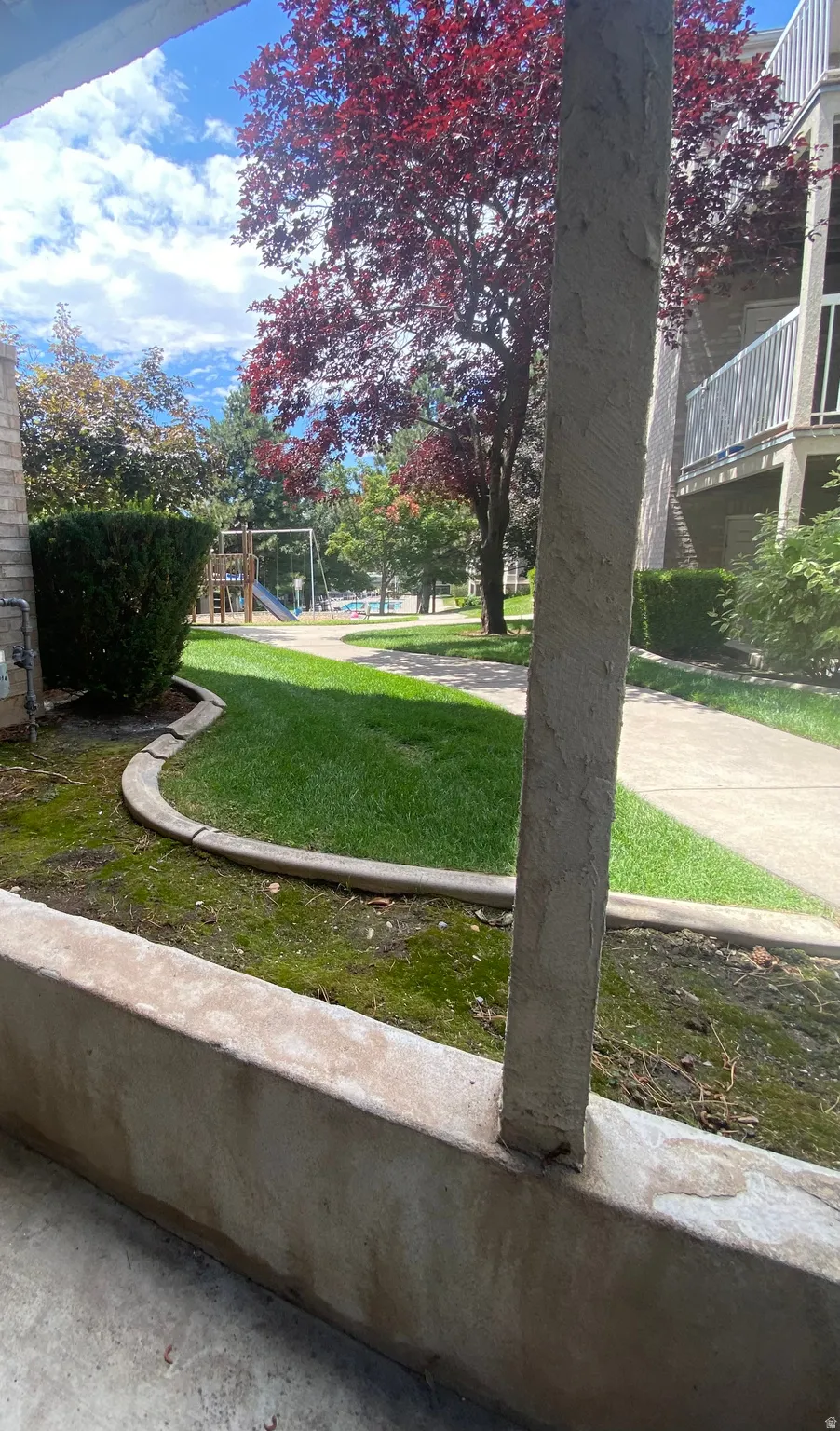 Outdoor patio area featuring a concrete half-wall and column
