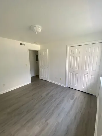 Room featuring light wood-finish flooring, white painted walls, and white baseboards