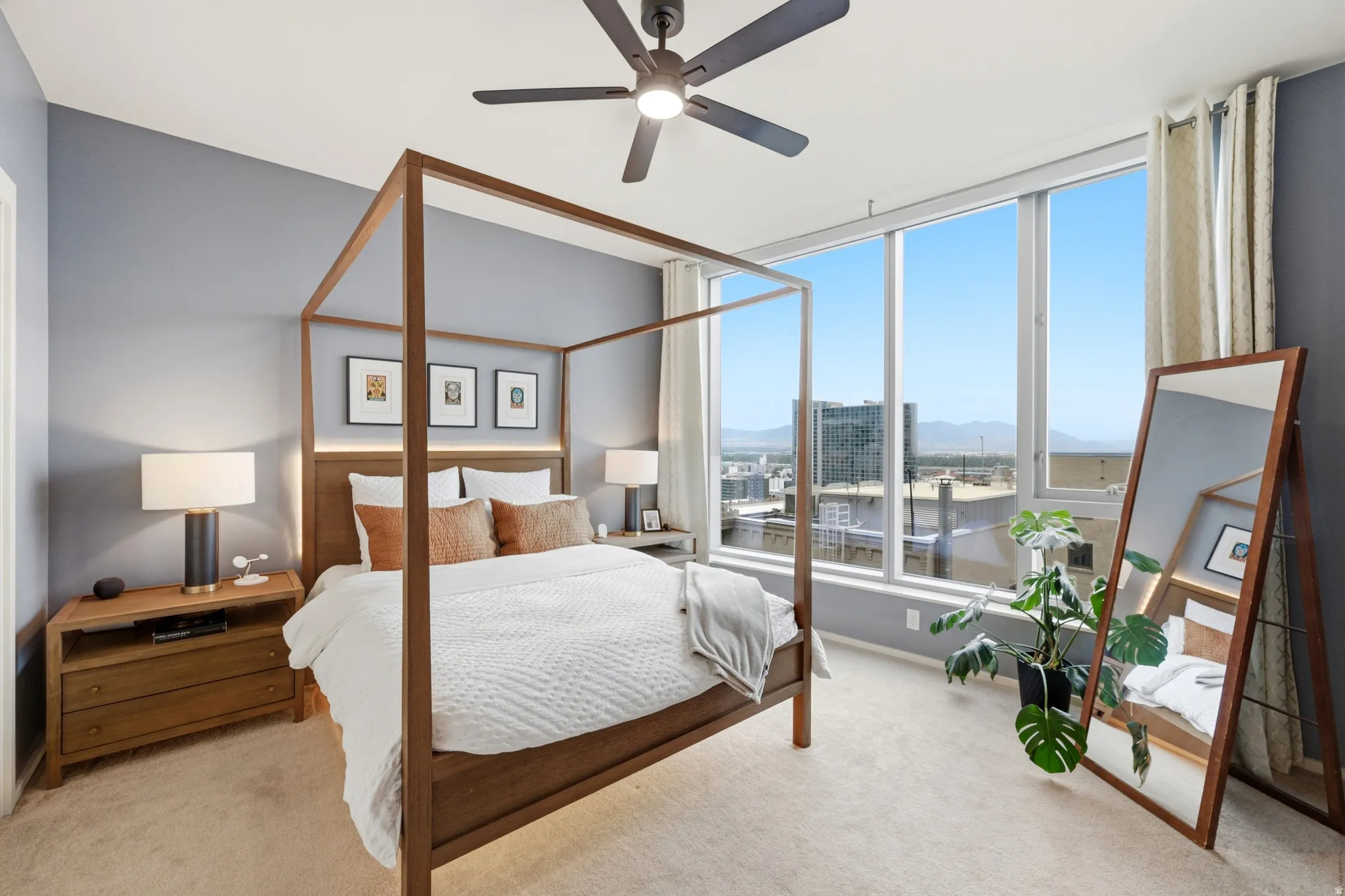 Expansive window wall with city and mountain scenery