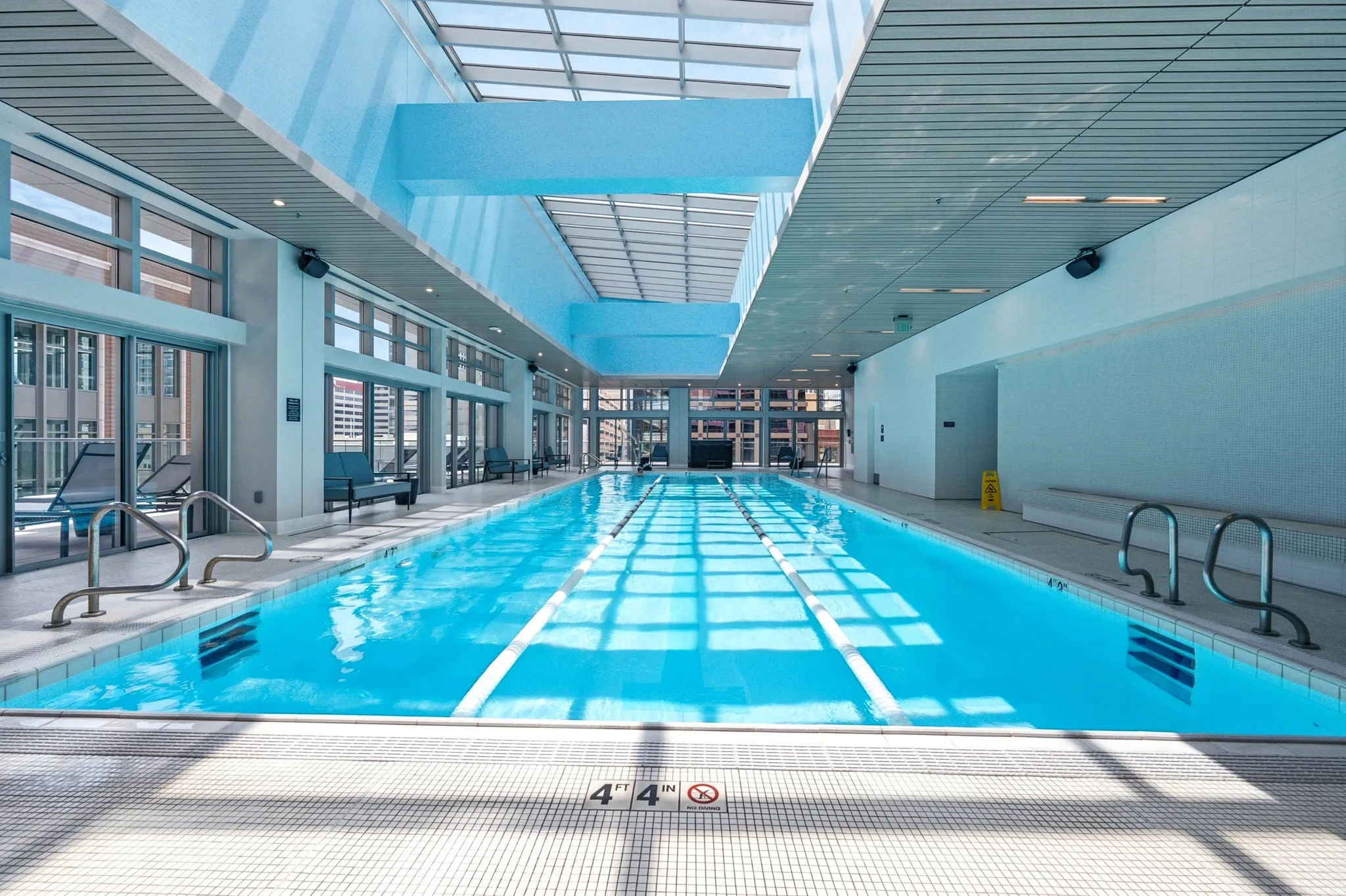 Indoor lap pool with bright blue water and lane lines