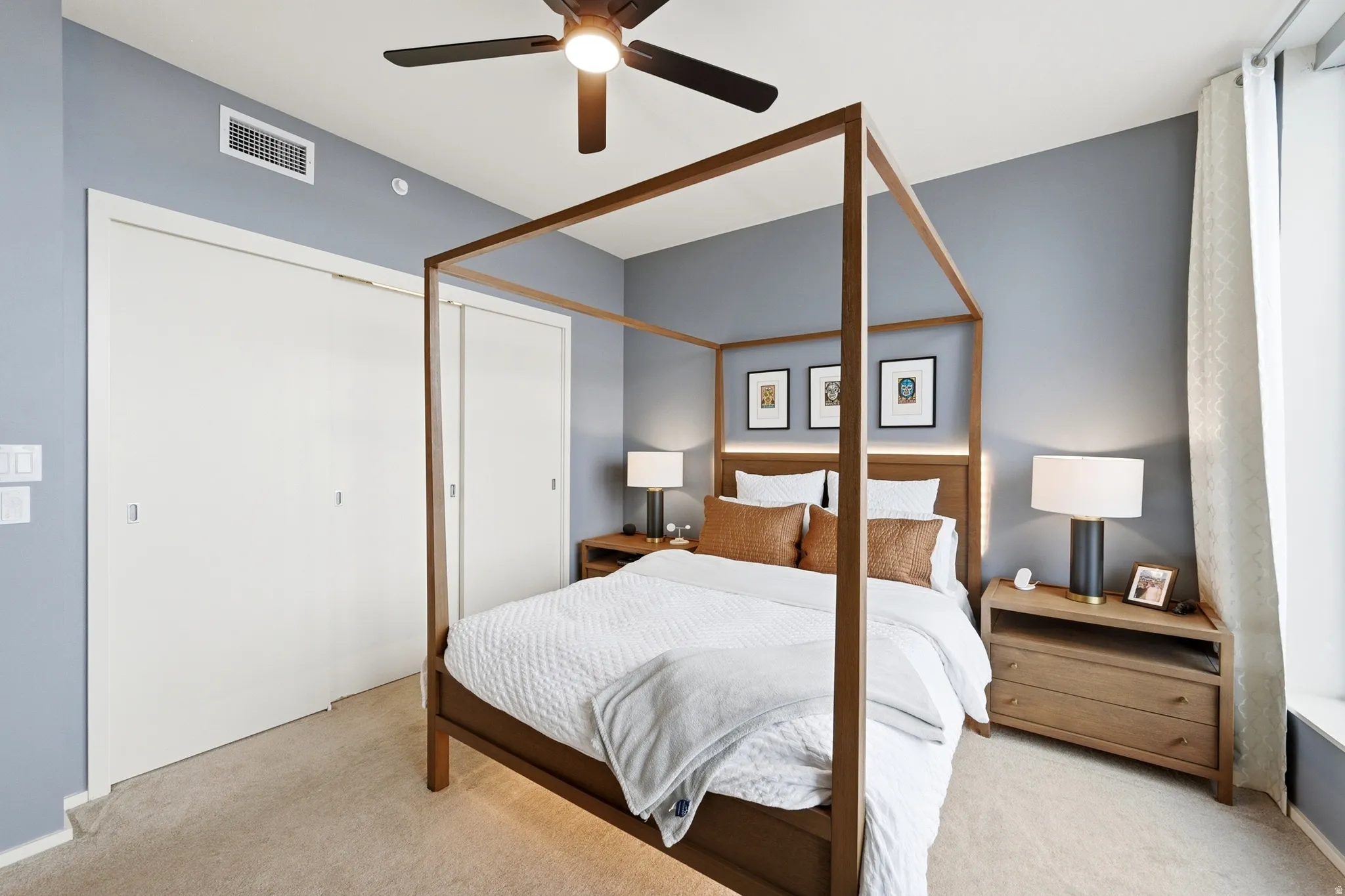 Bedroom featuring light neutral carpeting and cool-toned wall paint
