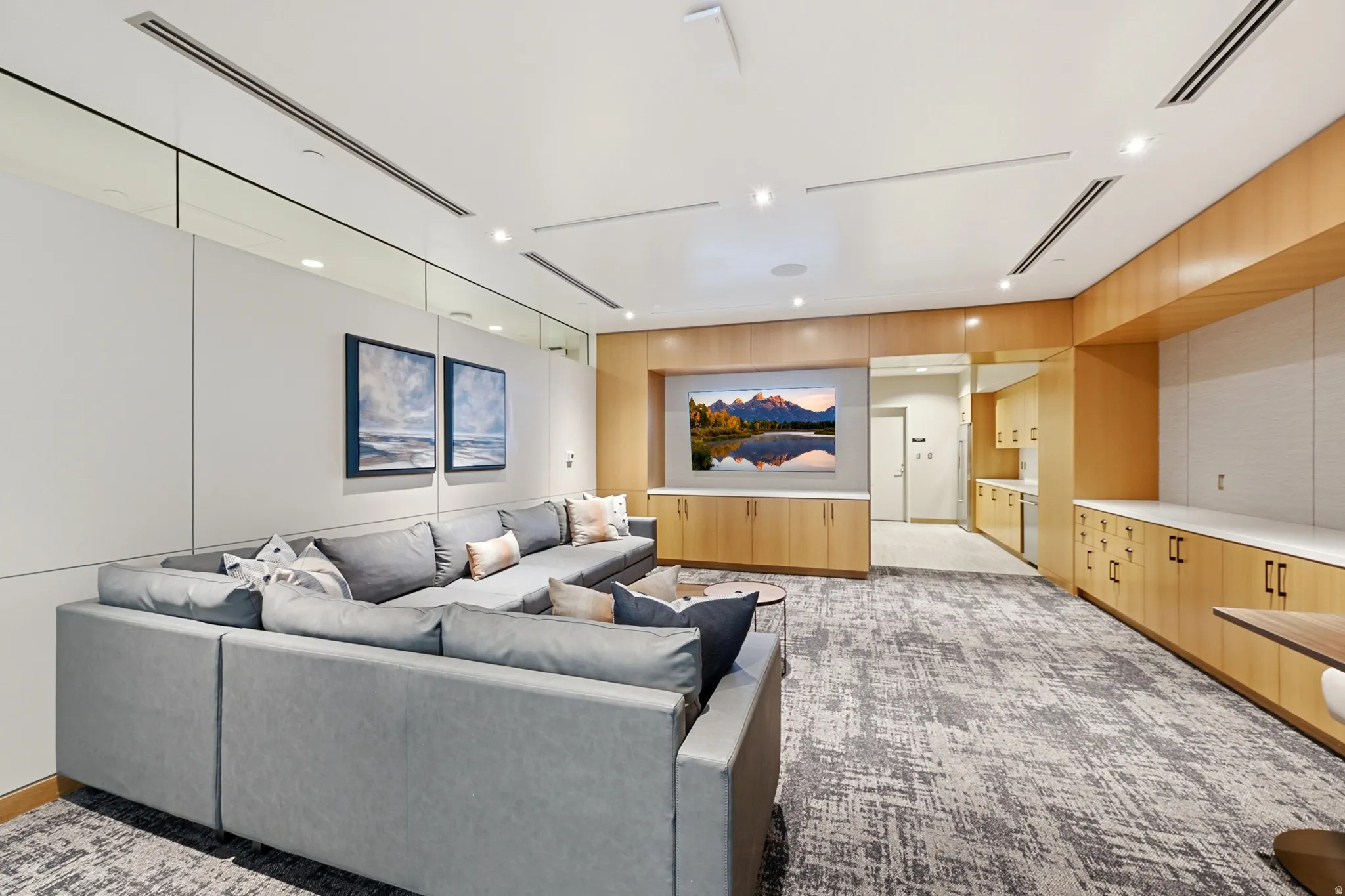 Spacious entertainment area featuring wood-finish cabinetry, built-in media center, and recessed lighting