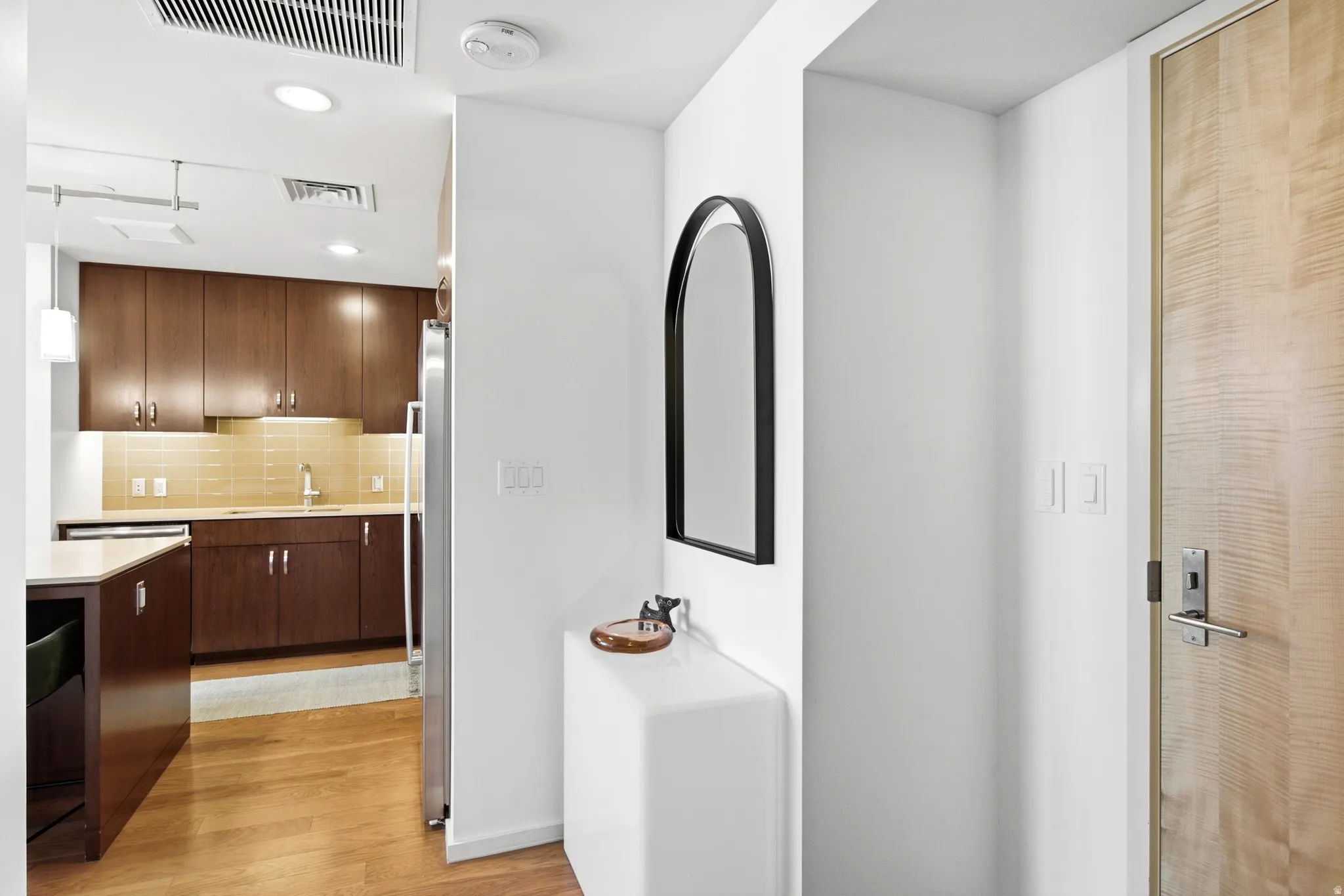 Wood-finish entry door with modern hardware
