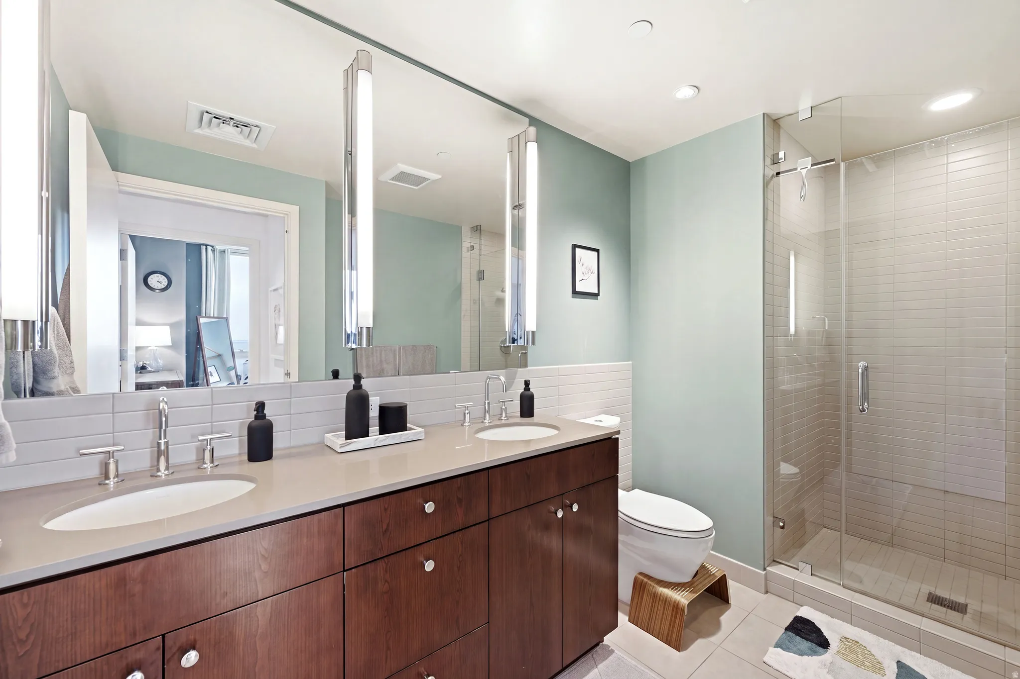 Double vanity with integrated sinks, brushed nickel fixtures, and a spacious wood-finish cabinet