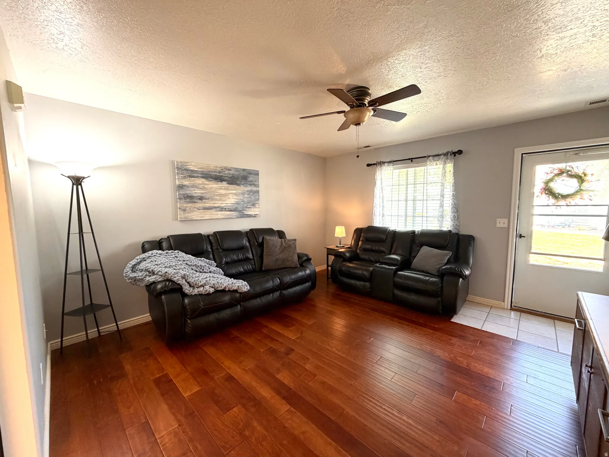 Warm wood-finish flooring complements light gray wall tones
