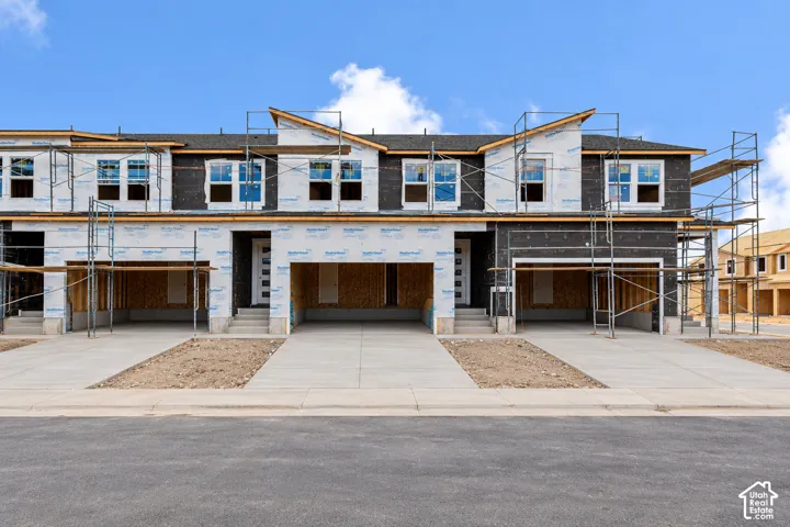 New construction townhomes with attached two-car garages and concrete driveways