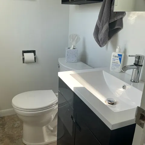 Modern vanity with an integrated white sink and polished chrome faucet