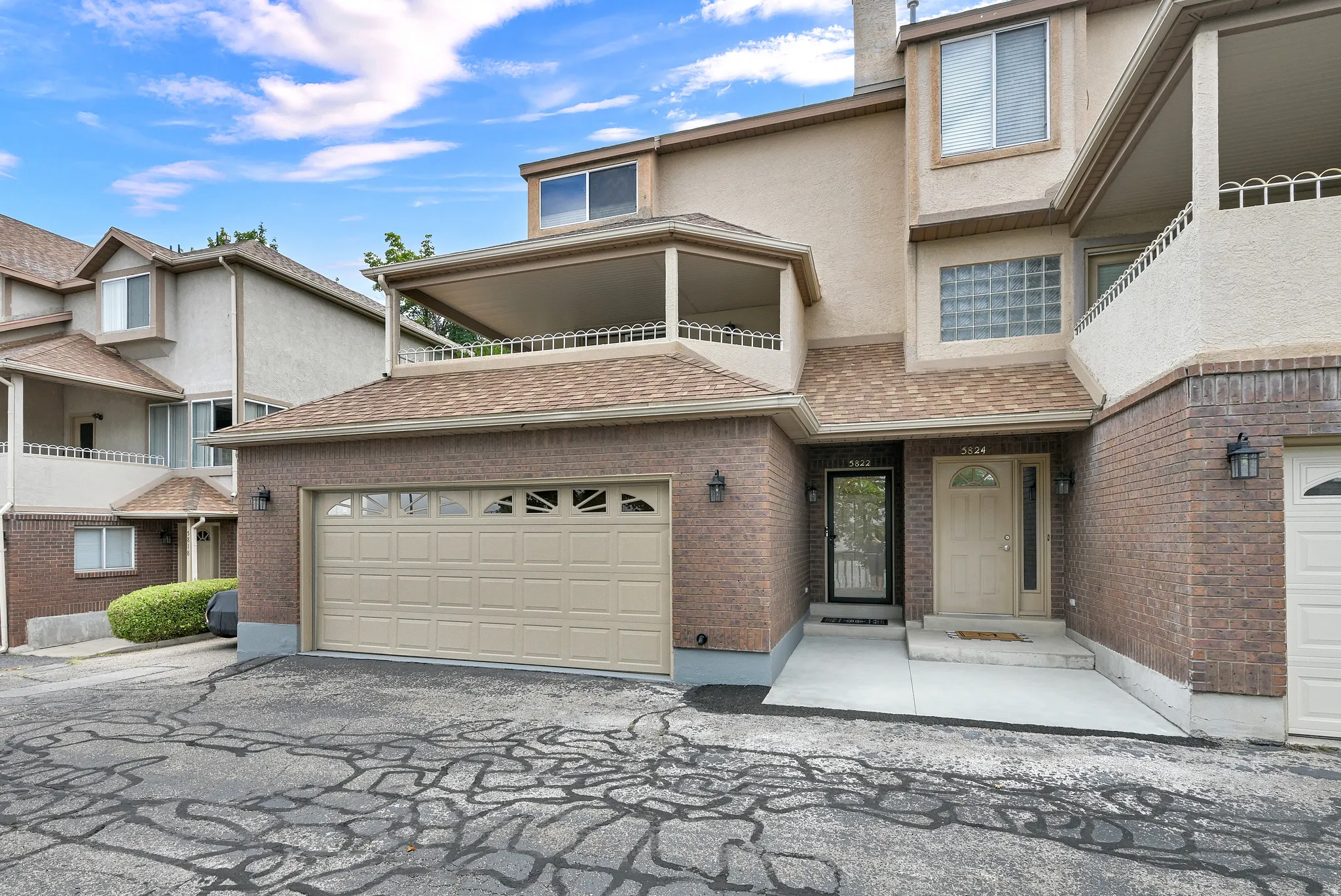 Multi-level property featuring a brick and stucco facade