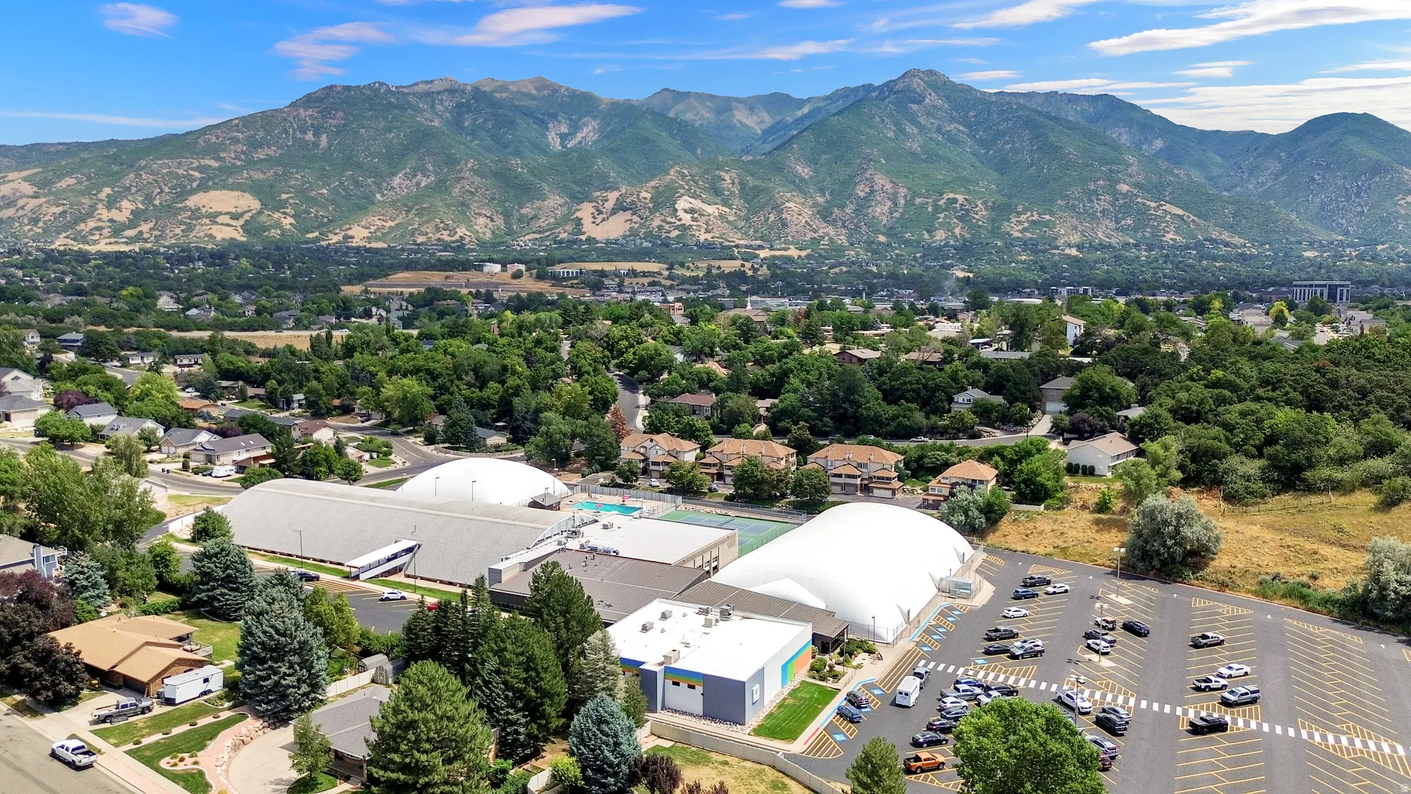 Expansive suburban landscape framed by distant mountains