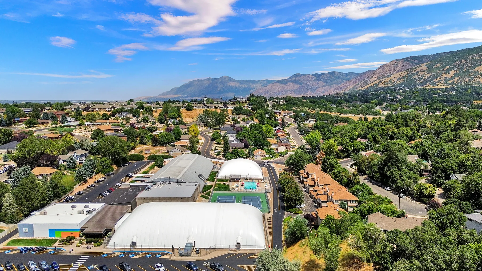 Expansive aerial perspective showcasing a residential area with a prominent recreational facility