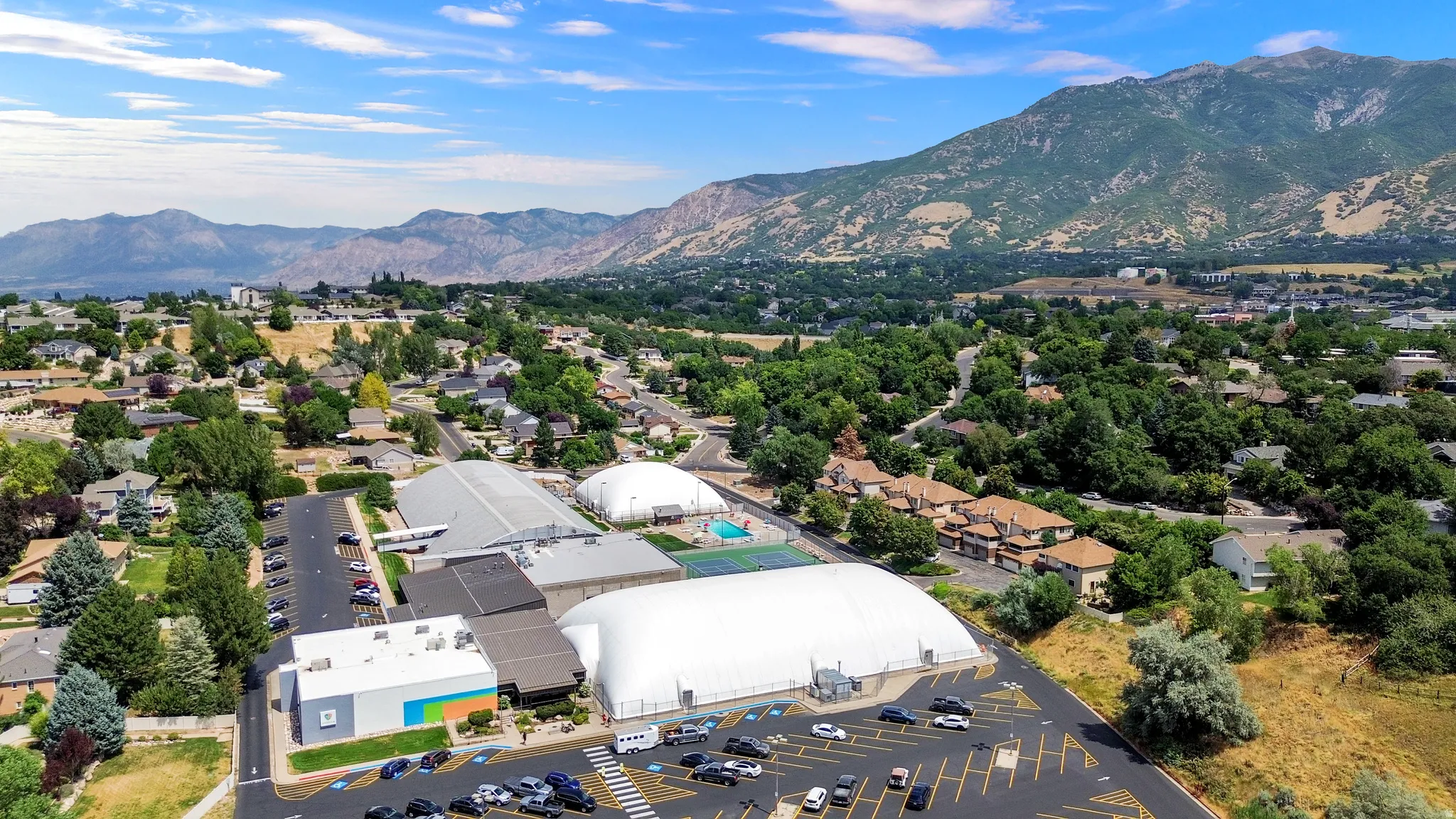 Aerial perspective showcasing a multi-building complex with extensive parking areas