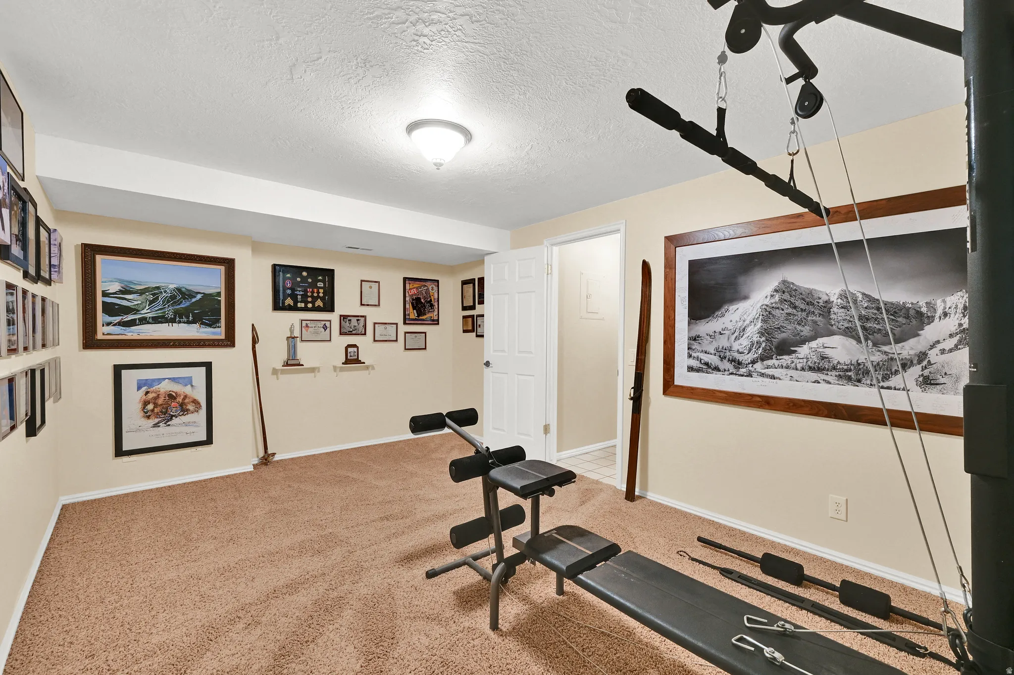 Carpeted room featuring light beige walls and a white ceiling with recessed lighting