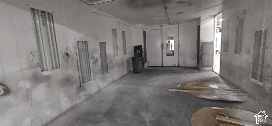 Concrete flooring throughout a large interior space, featuring multiple industrial-style wall vents