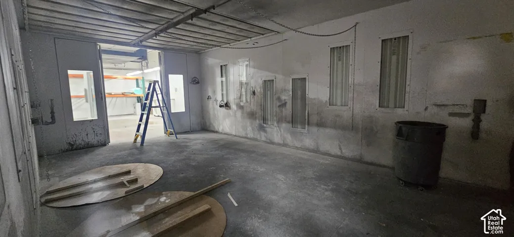 Industrial-style interior featuring concrete flooring and a suspended ceiling grid