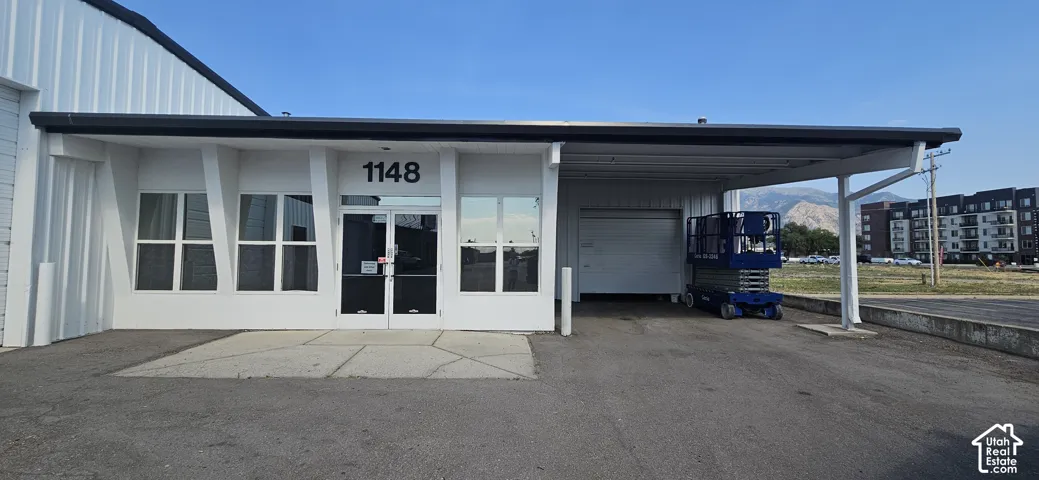 Modern commercial exterior featuring a white facade and dark trim