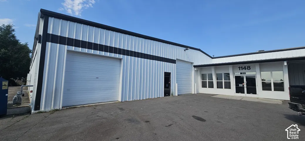 Commercial building featuring a corrugated metal exterior with contrasting black accents