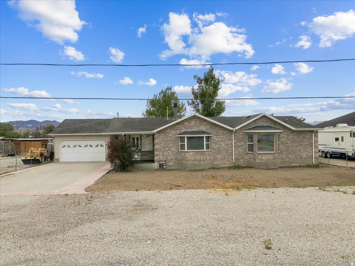 Brick exterior with an attached garage and concrete driveway