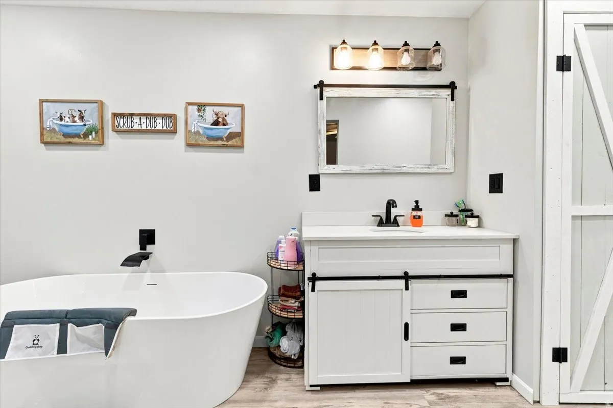 Freestanding soaking tub with a wall-mounted matte black faucet