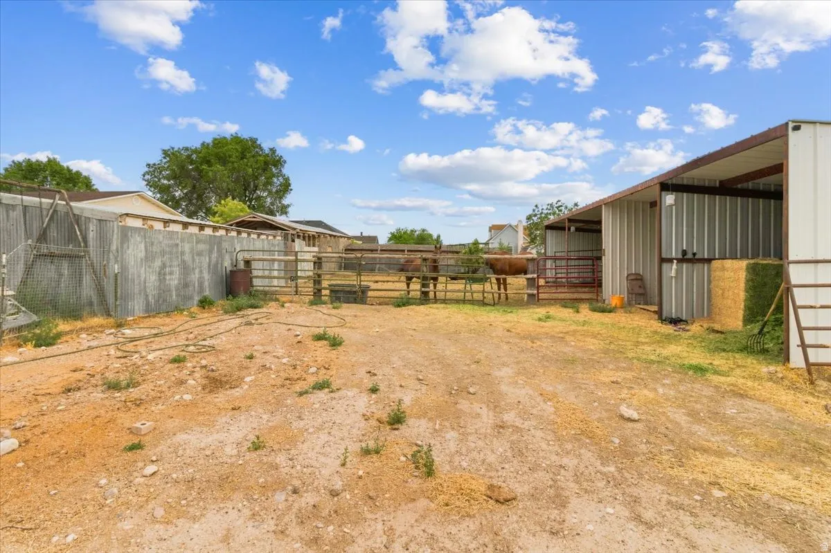 Outdoor equestrian facilities featuring covered stalls and metal fencing
